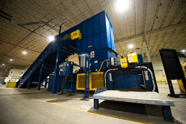 Image of a blue two ram baler