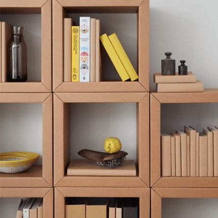 A sturdy shelf made out of folded cardboard boxes.